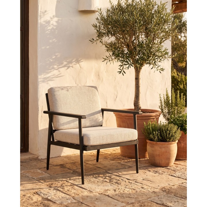 Black steel lounge armchair with grey cushions – in situ